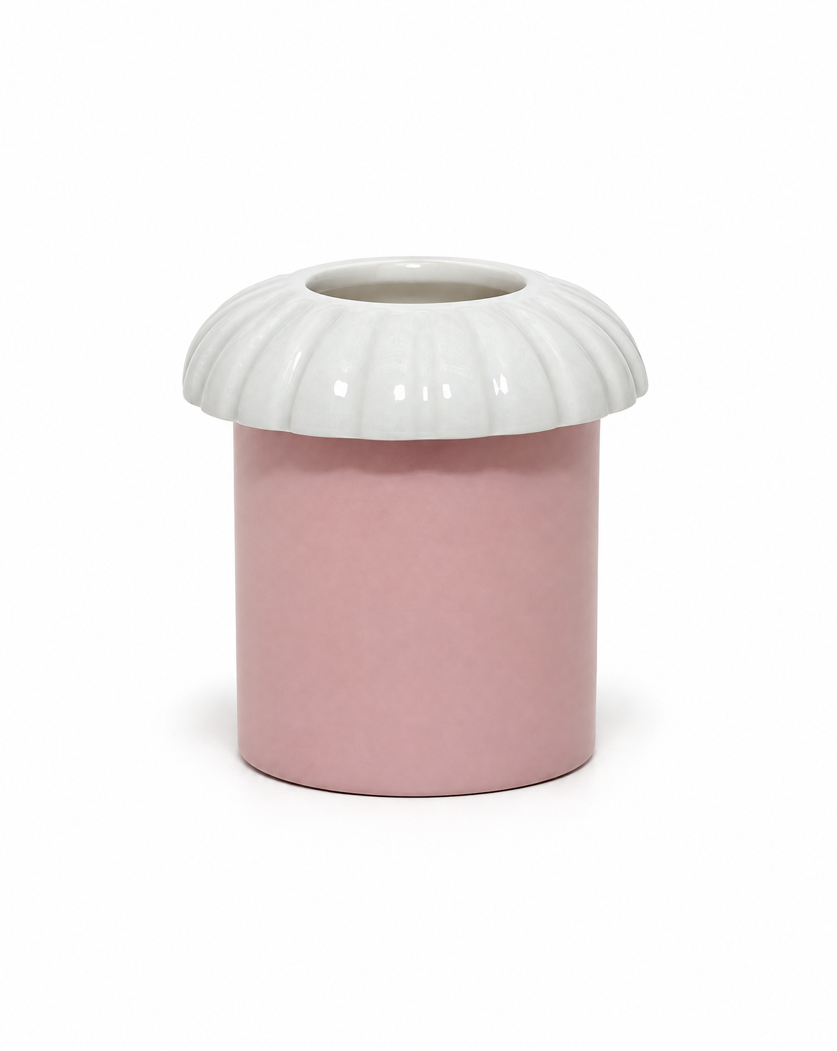 Porcelain candle topper in Fog, a white color, with ridged edges, resting on a jar candle in a pink vessel, shown on a white background.